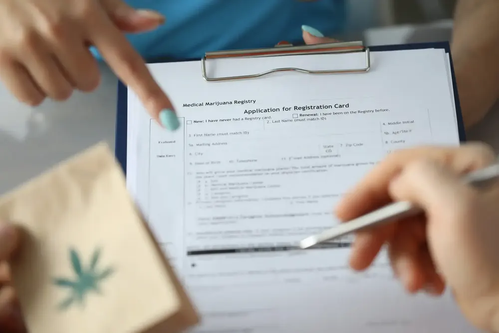 Clipboard with a Massachusetts medical marijuana registration form and a pen
