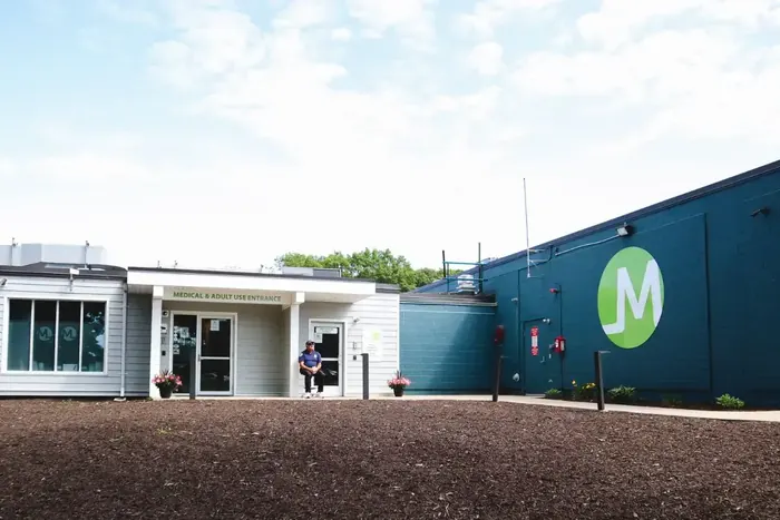 Triple M Plymouth building in the Plymouth Industrial Park, navy siding with the green Triple M leaf mark