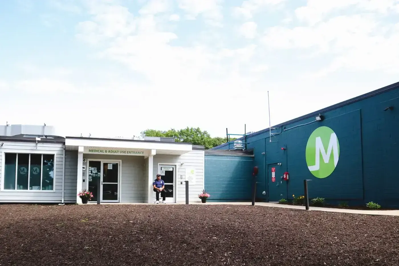 Triple M Plymouth building in the Plymouth Industrial Park, navy siding with the green Triple M leaf mark